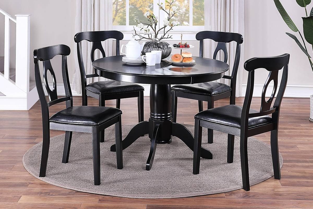 Round dining table with four chairs
